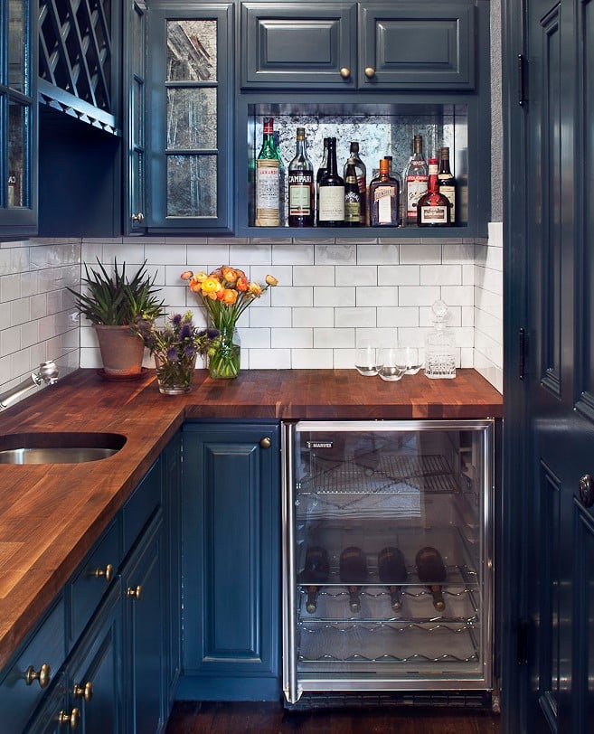 Blue cabinets in a white kitchen