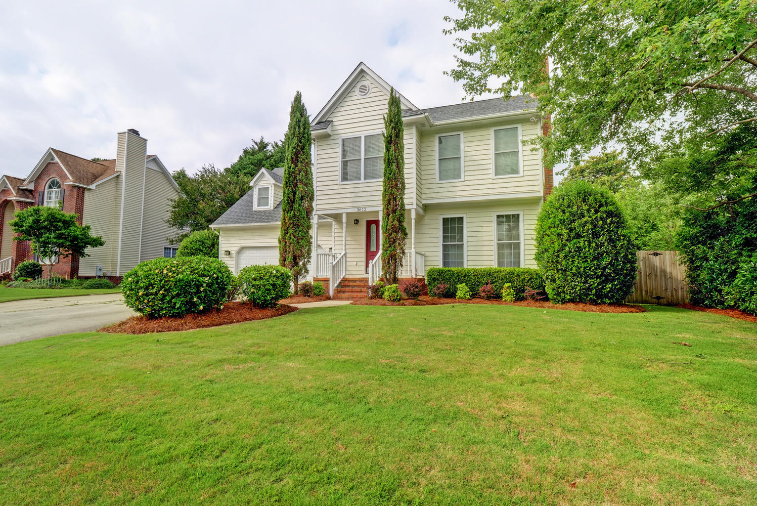 italian-cypress-trees-in-front-of-house-the-cameron-team