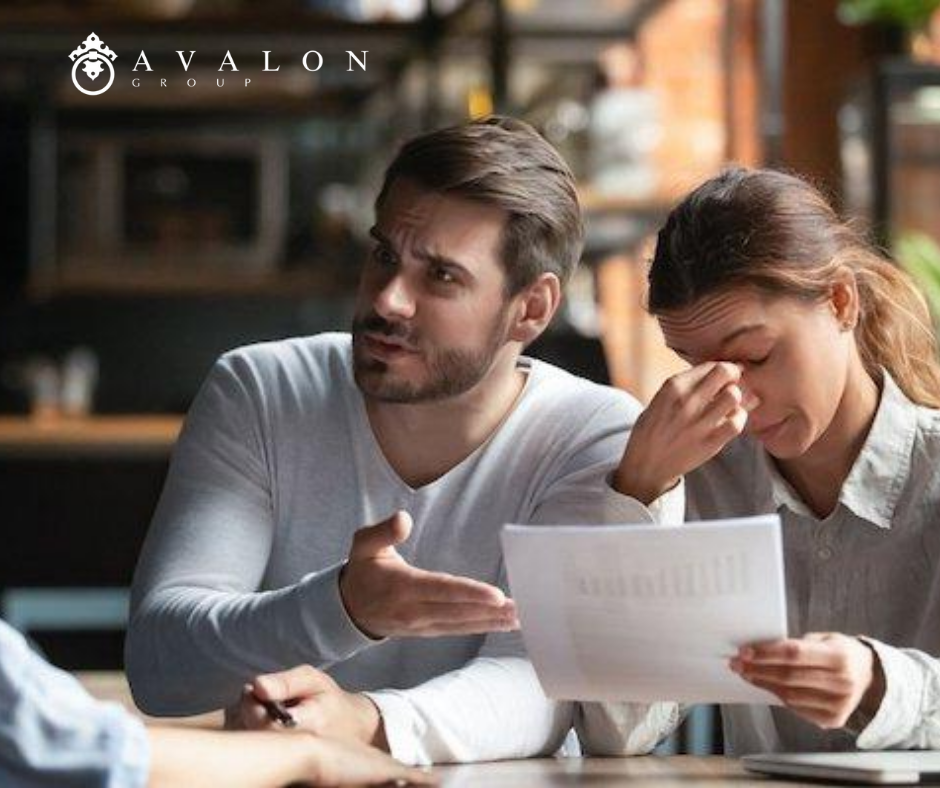 And in the picture there is a woman and man that are upset about what they are being told. The man is wearing a white sweater.