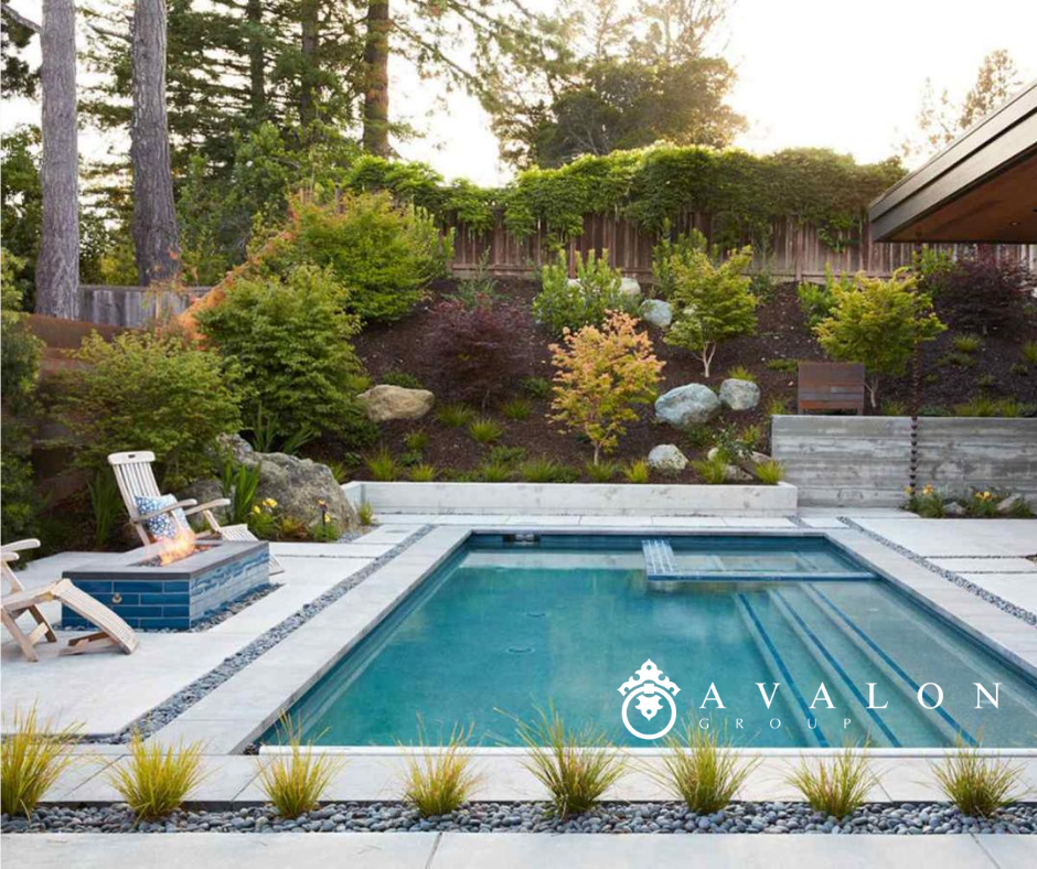 Additionally, the aqua colored pool is clear with many steps. Also the landscaping surrounds the pool cement deck..