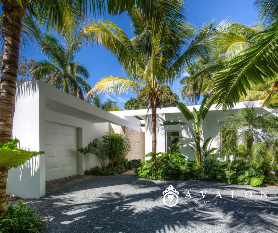 Furthermore, this mid century modern home 's exterior is white stucco. And the palm trees with extra green fronds create a tropical paradise feeling.
