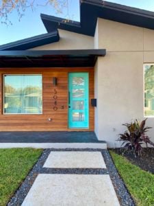 Patti's House Has a "Tiffany Blue" Front Door It is surrounded by a wood facade.