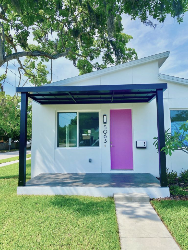 The front of the home designed for narrow lots. It is fabulous with the pink door.