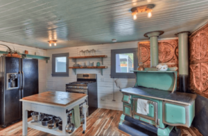 Kitchen with fridge, island, range, and antique teal stove