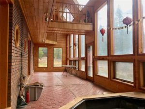 Open room with terracotta tile and 2-story windows