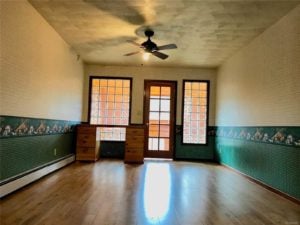 Room with wood floors, green wall paint, and glass block windows