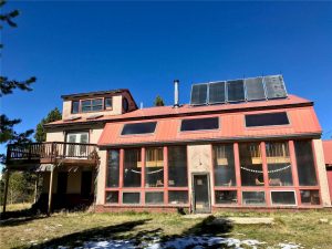 Exterior of home showing sunroom, solar panels