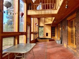 Terracotta tiling, huge windows, upper level wooden walkway